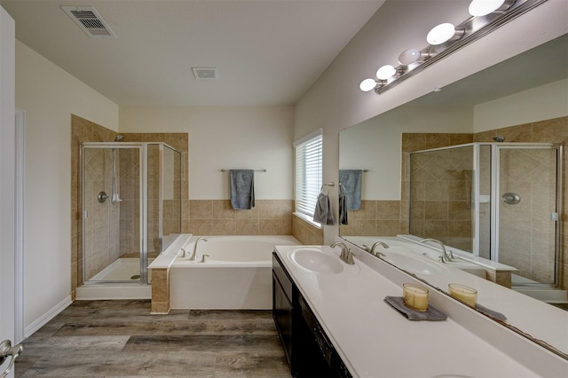 bathroom with vanity, shower with separate bathtub, and hardwood / wood-style flooring