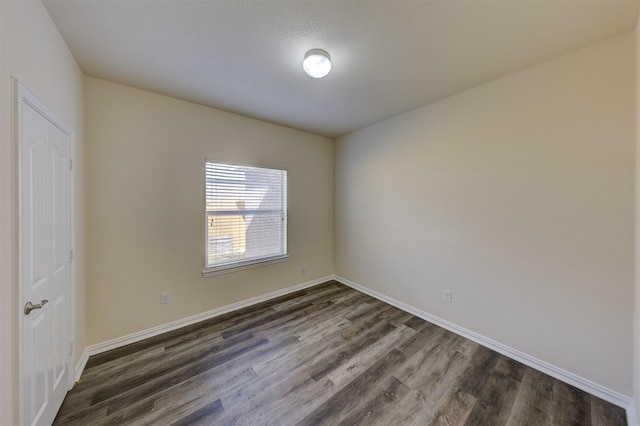 spare room with dark hardwood / wood-style floors