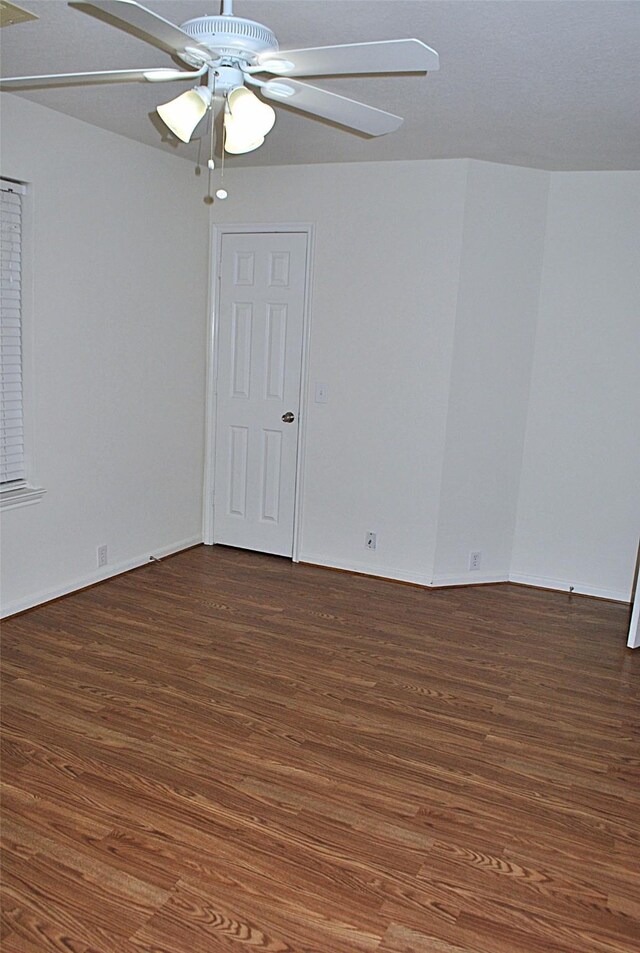 unfurnished room featuring ceiling fan and dark hardwood / wood-style floors