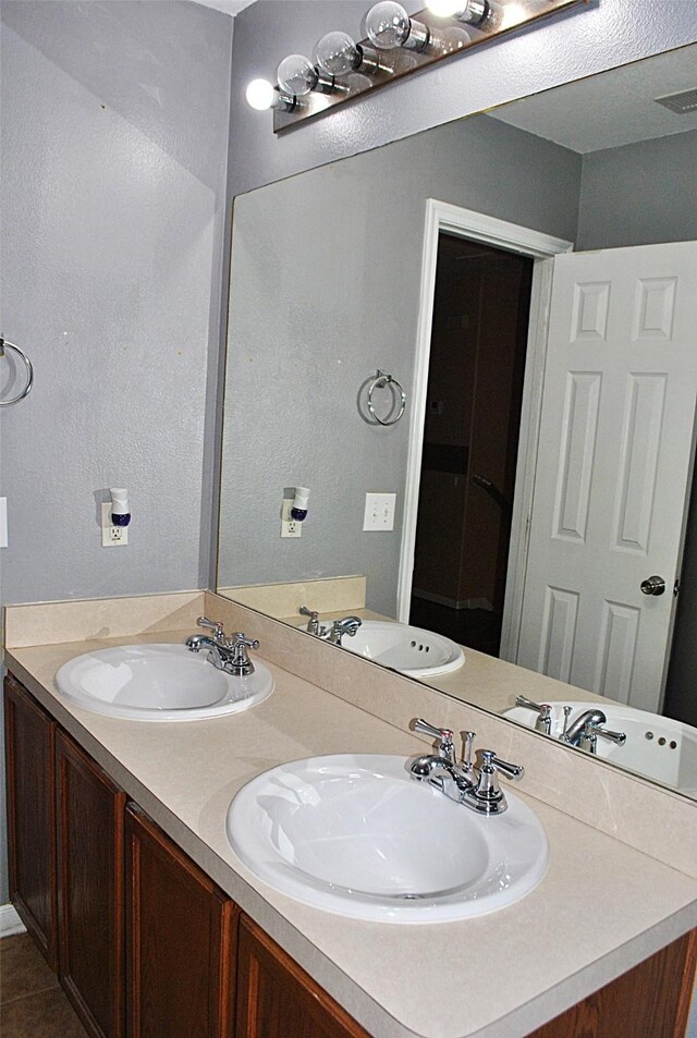 bathroom featuring tile patterned floors and vanity