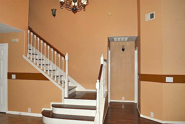 stairway with a chandelier