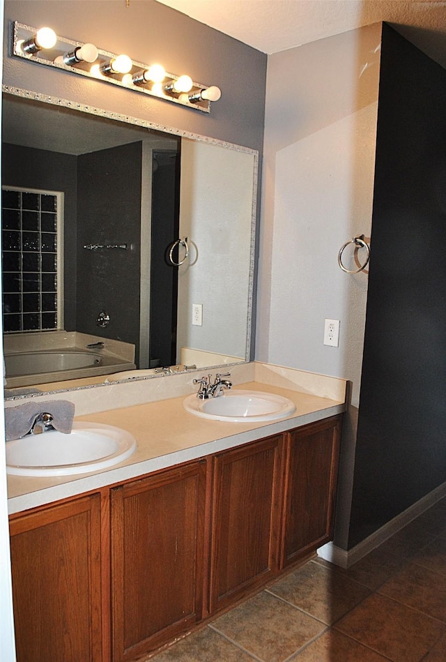 bathroom with tile patterned flooring, vanity, and a washtub