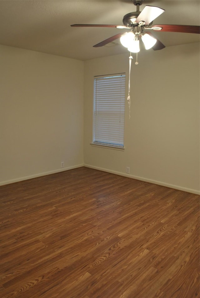 unfurnished room with dark wood finished floors, baseboards, and ceiling fan