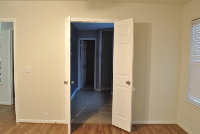 interior space featuring baseboards and wood finished floors