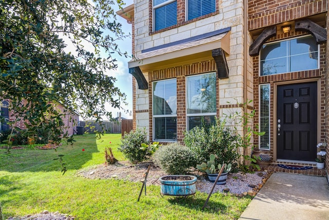 doorway to property with a lawn