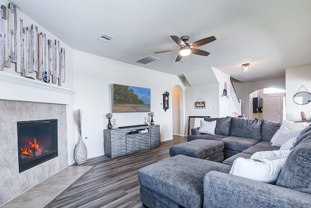 living room featuring a fireplace, ceiling fan, and dark hardwood / wood-style flooring