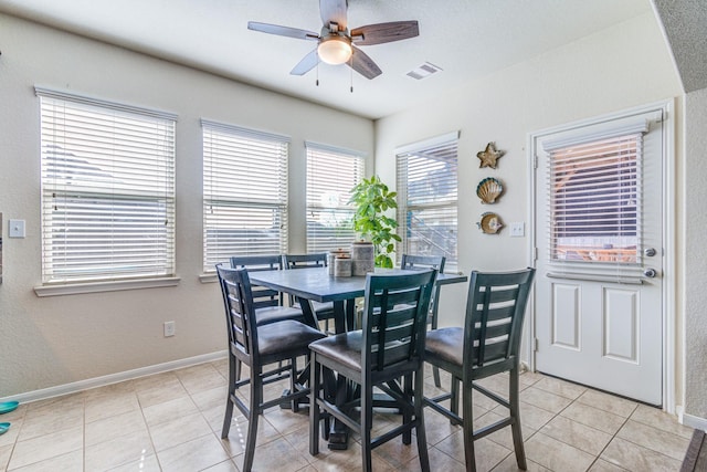 dining area with light tile patterned floors and ceiling fan