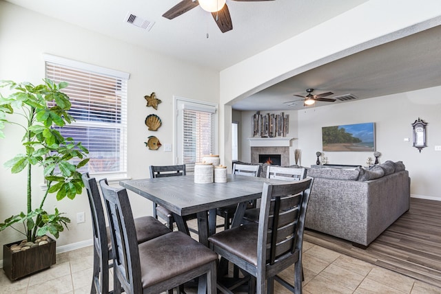 dining space featuring ceiling fan and light wood-type flooring