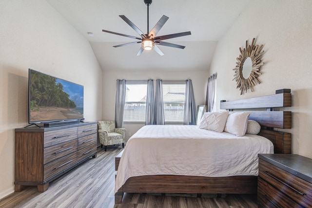 bedroom featuring light wood-type flooring, ceiling fan, and lofted ceiling