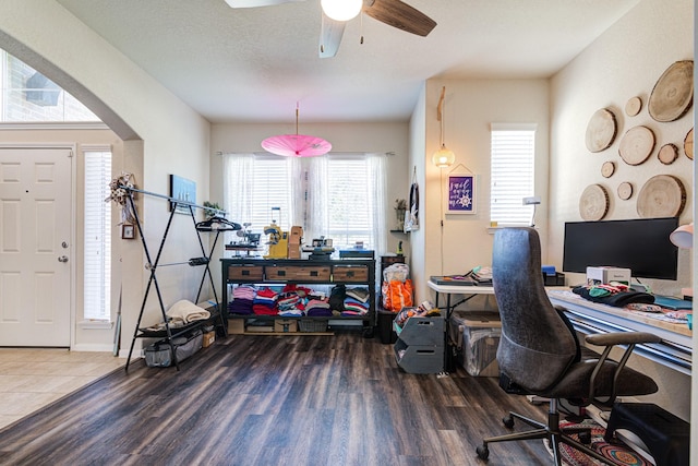 office area with a textured ceiling, ceiling fan, a healthy amount of sunlight, and dark hardwood / wood-style floors