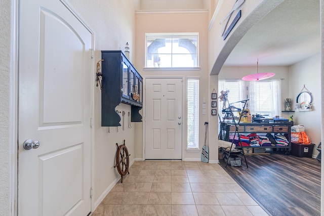 foyer featuring light tile patterned flooring and a textured ceiling