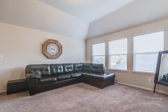 carpeted living room featuring lofted ceiling