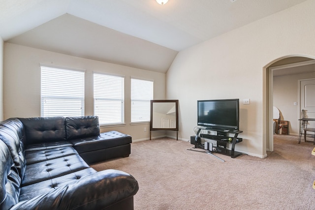 living room featuring light carpet and vaulted ceiling