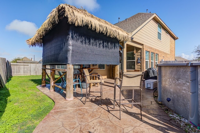 rear view of property with a lawn and a patio area