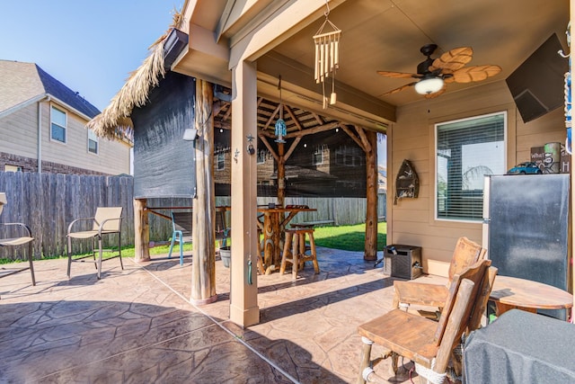 view of patio / terrace with ceiling fan and exterior bar