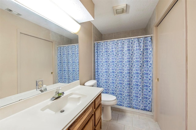 bathroom featuring tile patterned floors, vanity, a textured ceiling, and toilet