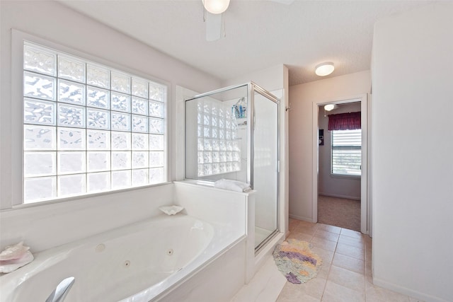 bathroom with tile patterned floors, plus walk in shower, and a healthy amount of sunlight