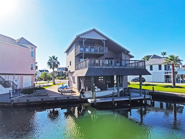 back of property featuring a water view