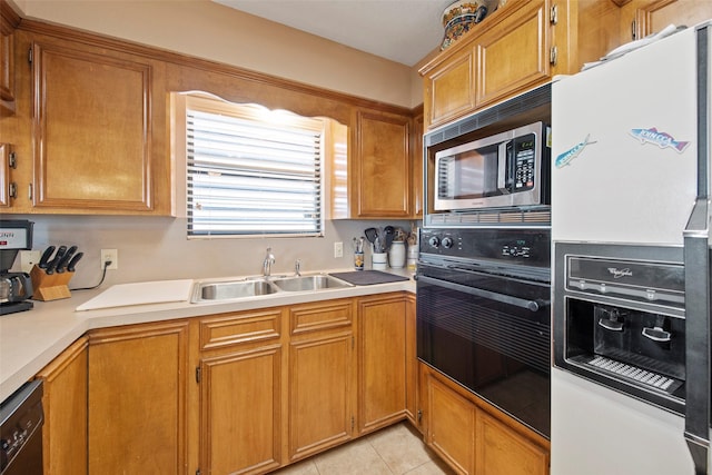 kitchen with light tile patterned floors, sink, and black appliances