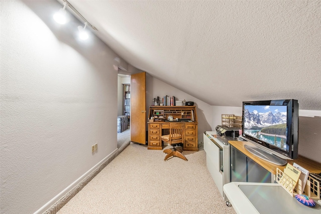 office space with carpet flooring, rail lighting, a textured ceiling, and vaulted ceiling