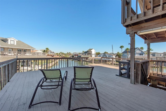 wooden terrace featuring a water view