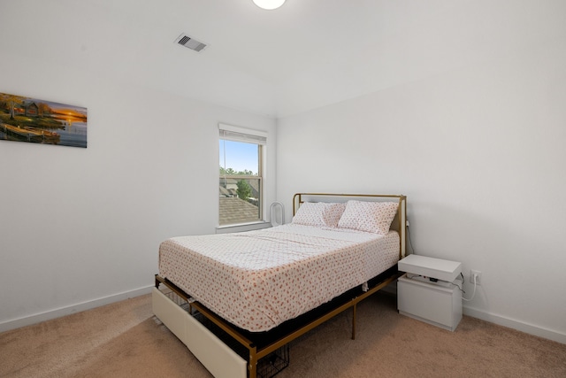 bedroom featuring light colored carpet