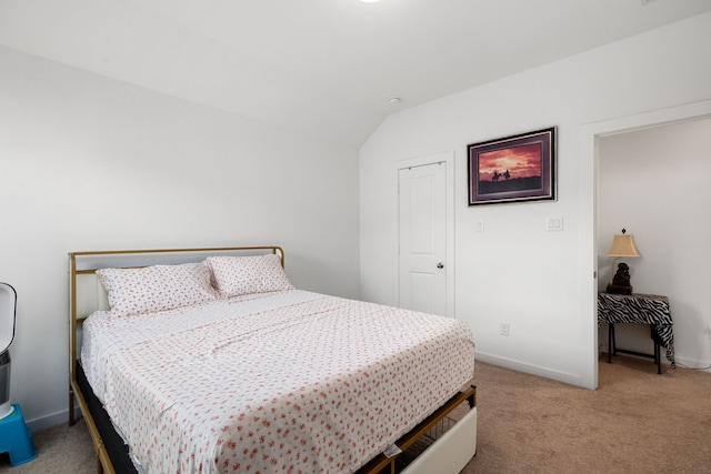 carpeted bedroom with vaulted ceiling