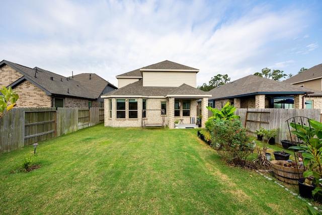 rear view of property with a lawn