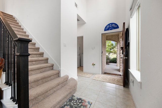 tiled entryway featuring a high ceiling