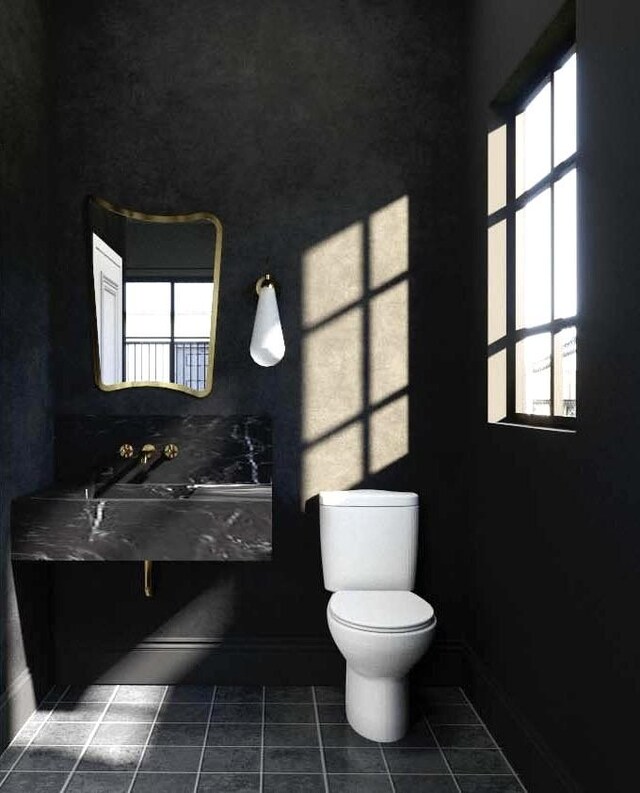 bathroom with tile patterned flooring, a healthy amount of sunlight, and toilet