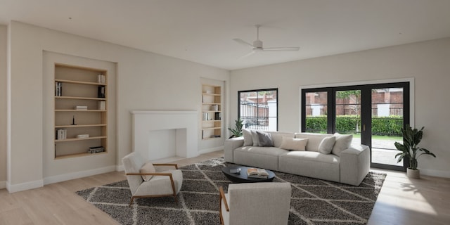 living room with light wood-type flooring, ceiling fan, built in shelves, and baseboards