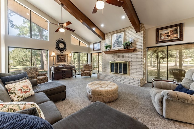 carpeted living room with ceiling fan, beamed ceiling, high vaulted ceiling, and a brick fireplace