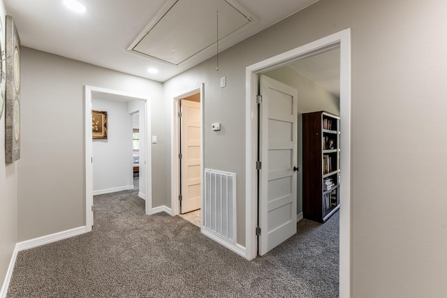 hallway with dark colored carpet