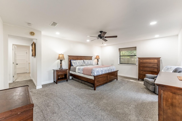 bedroom with ceiling fan and light carpet