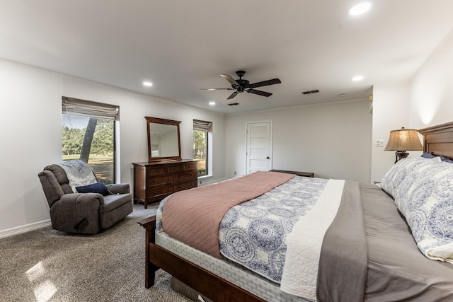 bedroom with multiple windows, light carpet, and ceiling fan