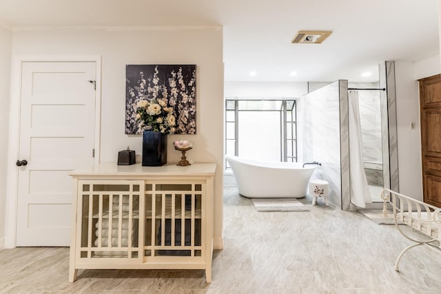 bathroom with separate shower and tub and ornamental molding