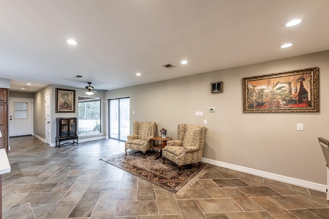 sitting room featuring ceiling fan