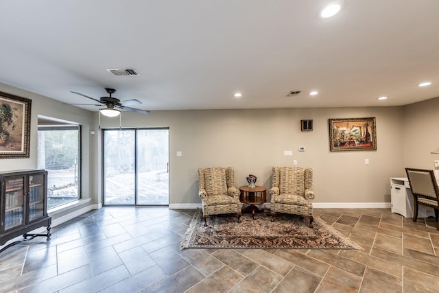 living area with ceiling fan