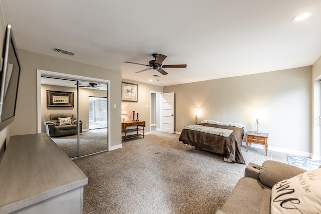 carpeted bedroom with ceiling fan and a closet