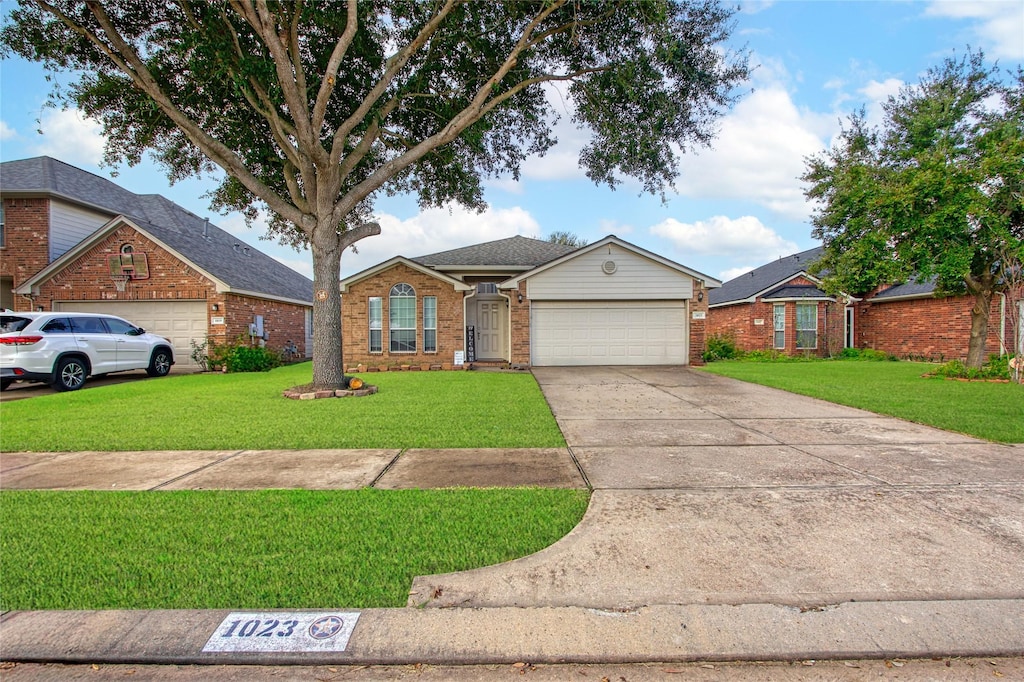 ranch-style home with a front lawn and a garage