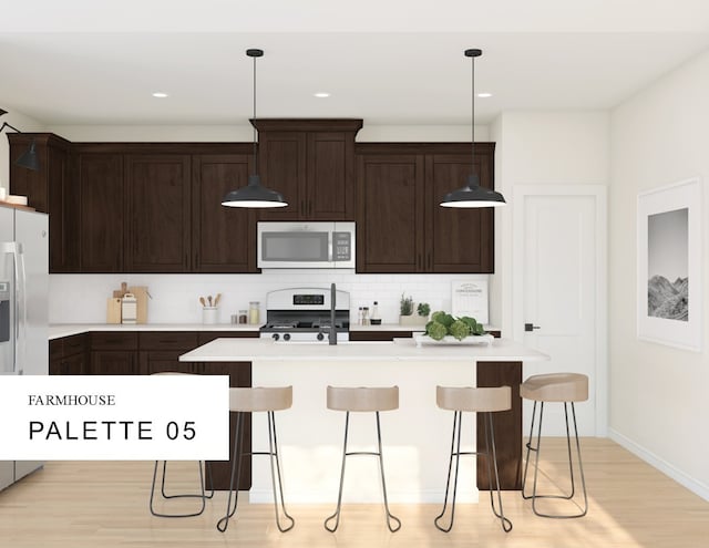 kitchen with dark brown cabinetry, tasteful backsplash, appliances with stainless steel finishes, a breakfast bar area, and light countertops