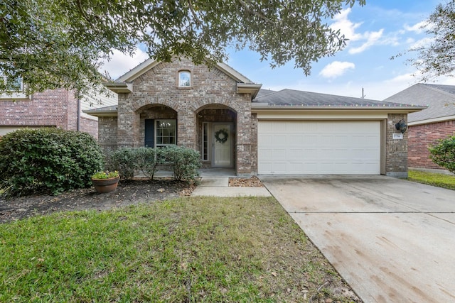 view of front of home with a garage and a front lawn