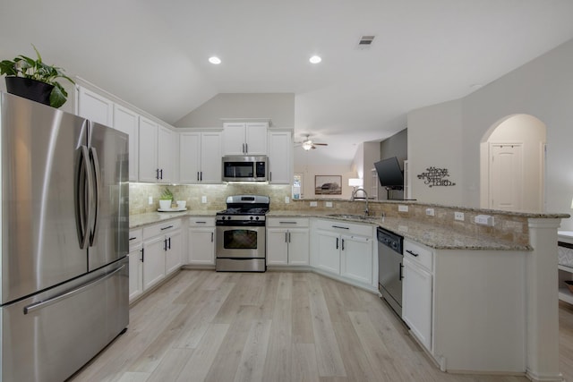 kitchen featuring white cabinets, sink, lofted ceiling, and stainless steel appliances