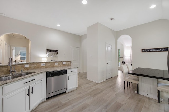 kitchen featuring dishwasher, white cabinets, sink, light stone countertops, and light hardwood / wood-style floors