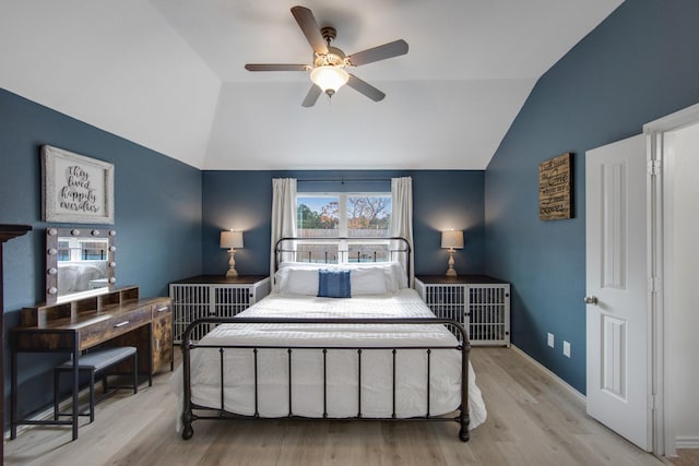 bedroom with light wood-type flooring, ceiling fan, and lofted ceiling