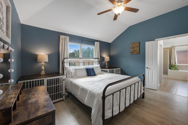 bedroom featuring radiator, ceiling fan, wood-type flooring, and vaulted ceiling