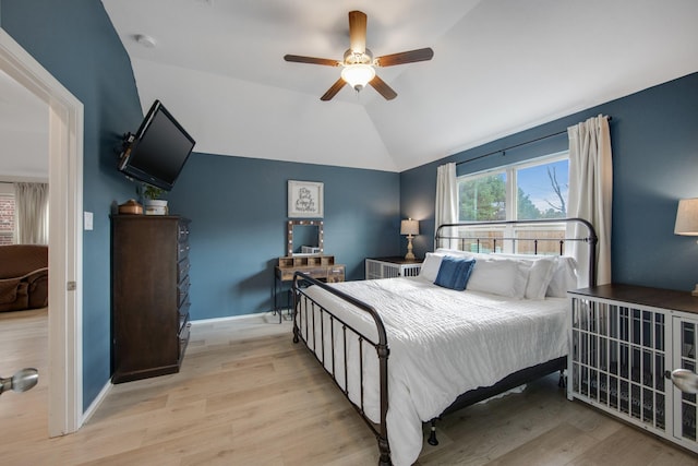 bedroom with light hardwood / wood-style flooring, ceiling fan, and lofted ceiling