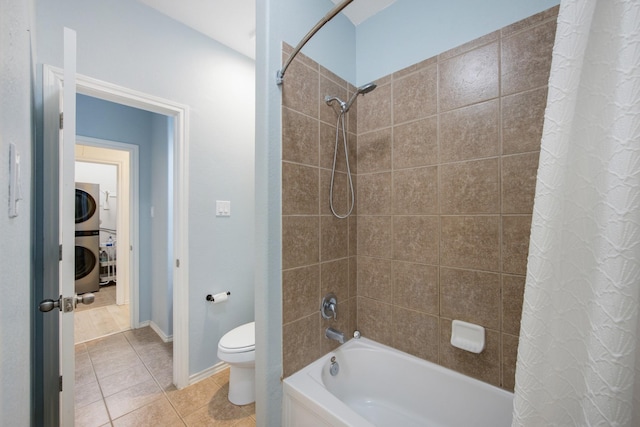 bathroom featuring tile patterned flooring, stacked washer and dryer, toilet, and shower / bathtub combination with curtain