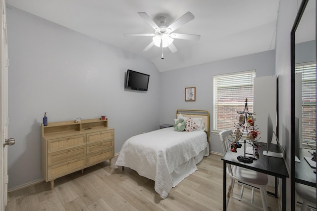 bedroom with ceiling fan, light wood-type flooring, and lofted ceiling