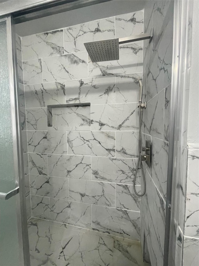 bathroom with a tile shower